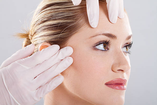 closeup of doctor conduct skin check before plastic surgery